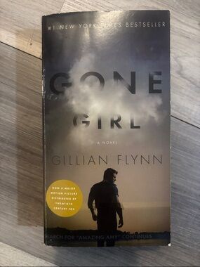 Gone Girl by Gillian Flynn - Paperback Novel (Dark Blue/Gray Cover)